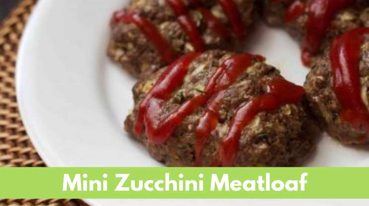 Individual sized meatloaf with grated zucchini ground beef and ketchup on top