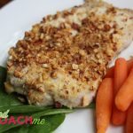 Pork chops coated with parmesan cheese, dijon mustard and chopped almonds with steamed carrots
