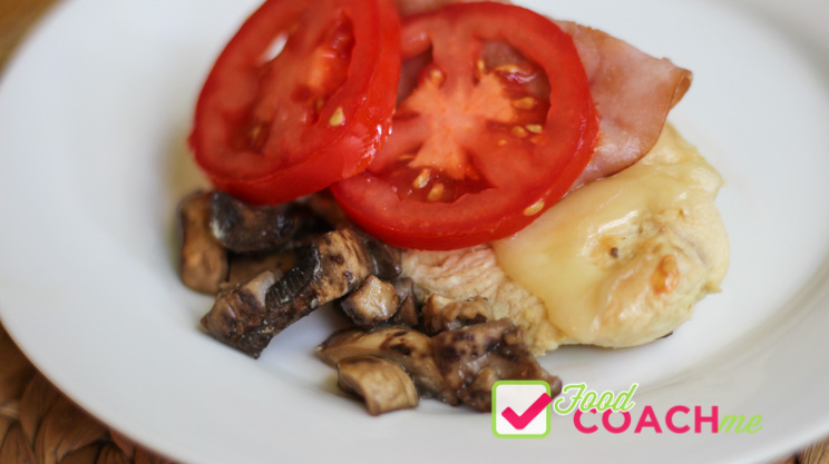 Chicken breast topped with swiss cheese, pan fried ham slice, tomatoes and sautÃ©ed mushrooms
