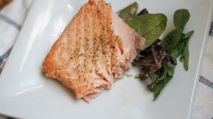 Flakey fresh salmon on a white plate made in air fryer for bariatric friendly recipe